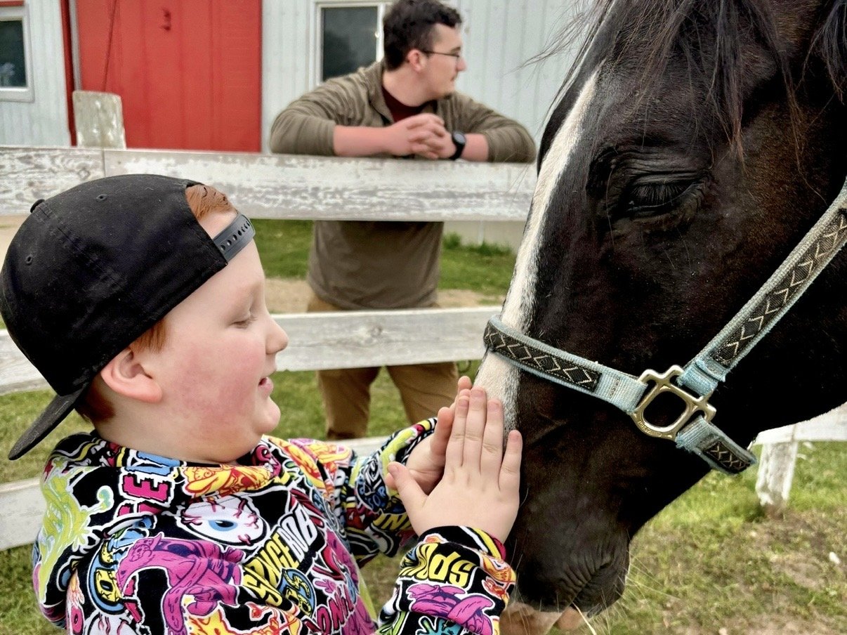 Boy Petting a Horse