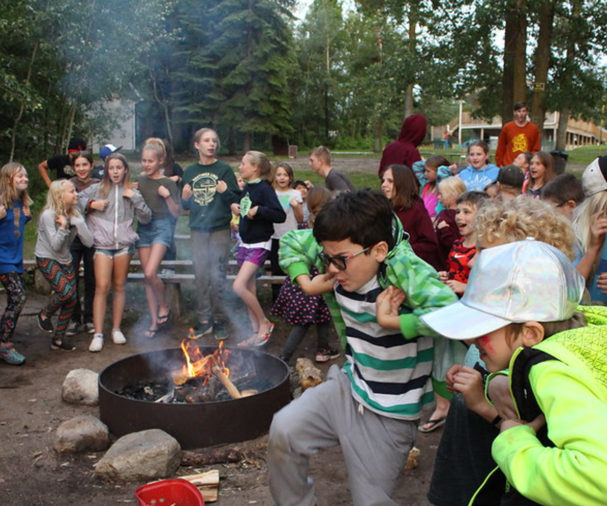 Kids Dancing Around a Campfire