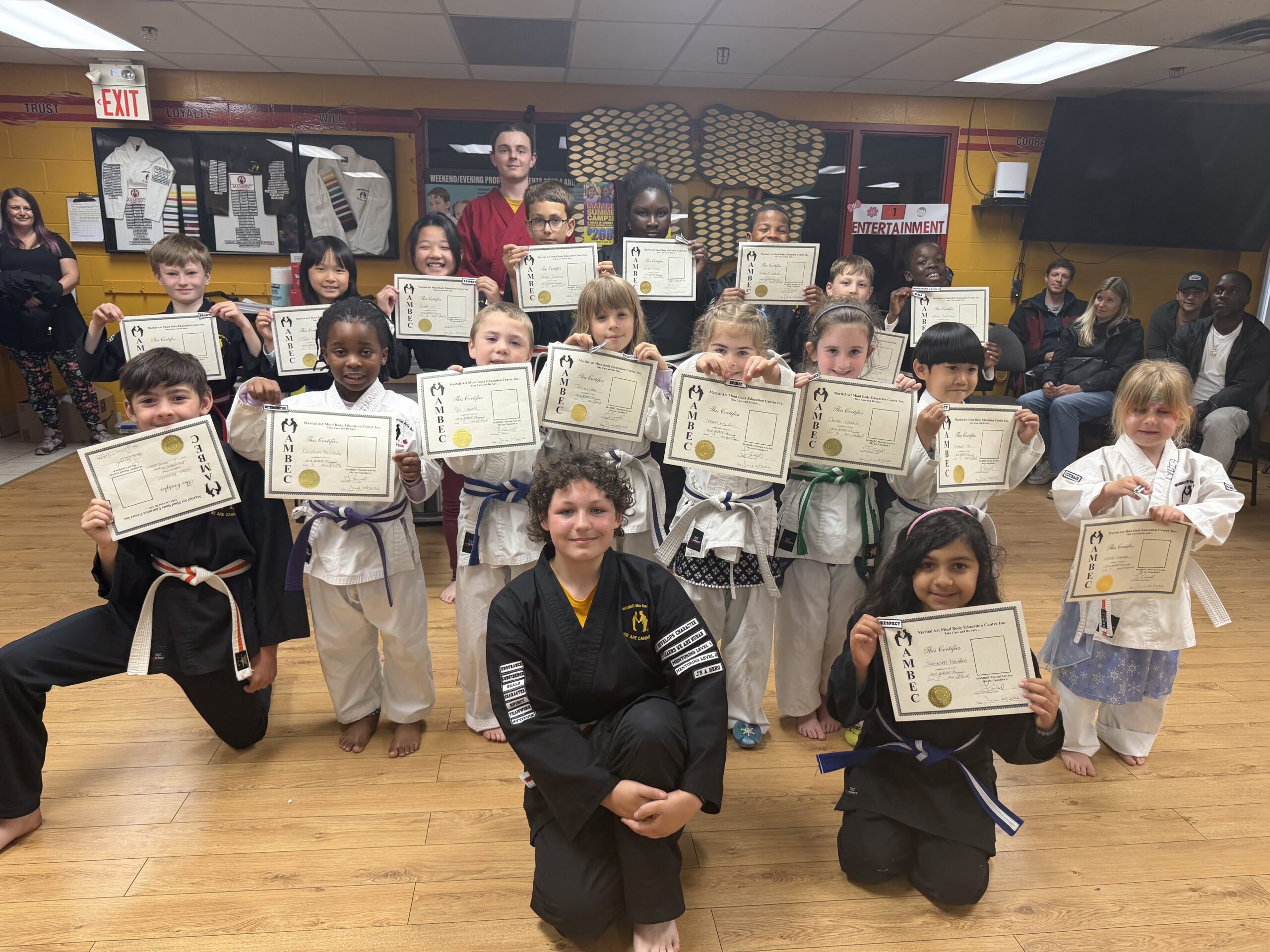 MAMBEC Martial Arts Youth in martial arts clothing holding their certificates from MAMBEC