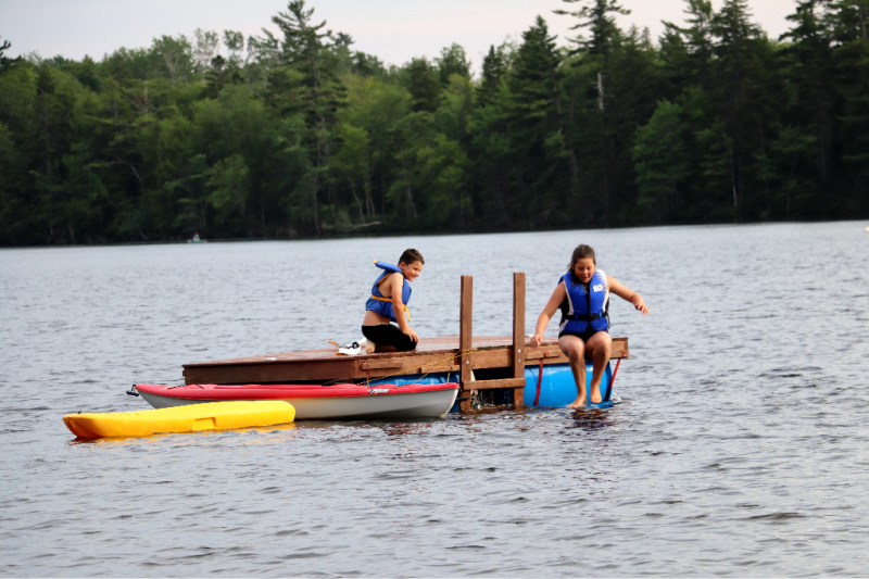 jumping into the water from a raft at Zwicker's lake in Nova Scotia