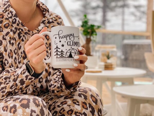 Girl wearing pyjamas cradles delicious mug of hot chocolate at Sissiboo River Retreat in Weymouth Nova Scotia