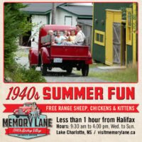 Youth in the back of a red 1940s pick up truck at Memory Lane