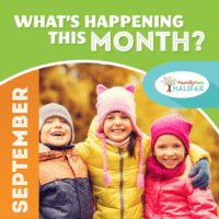 Three kids wearing jackets and hats embracing in front of yellow leaves in the fall