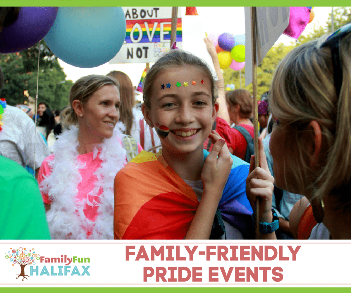 Smiling girl with pride flag over shoulders in a crowd of parade-goers