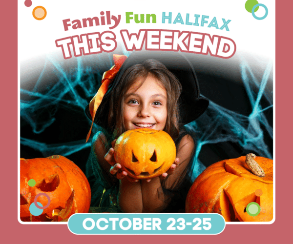 girl holding a jack o lantern in front of two carved pumpkins