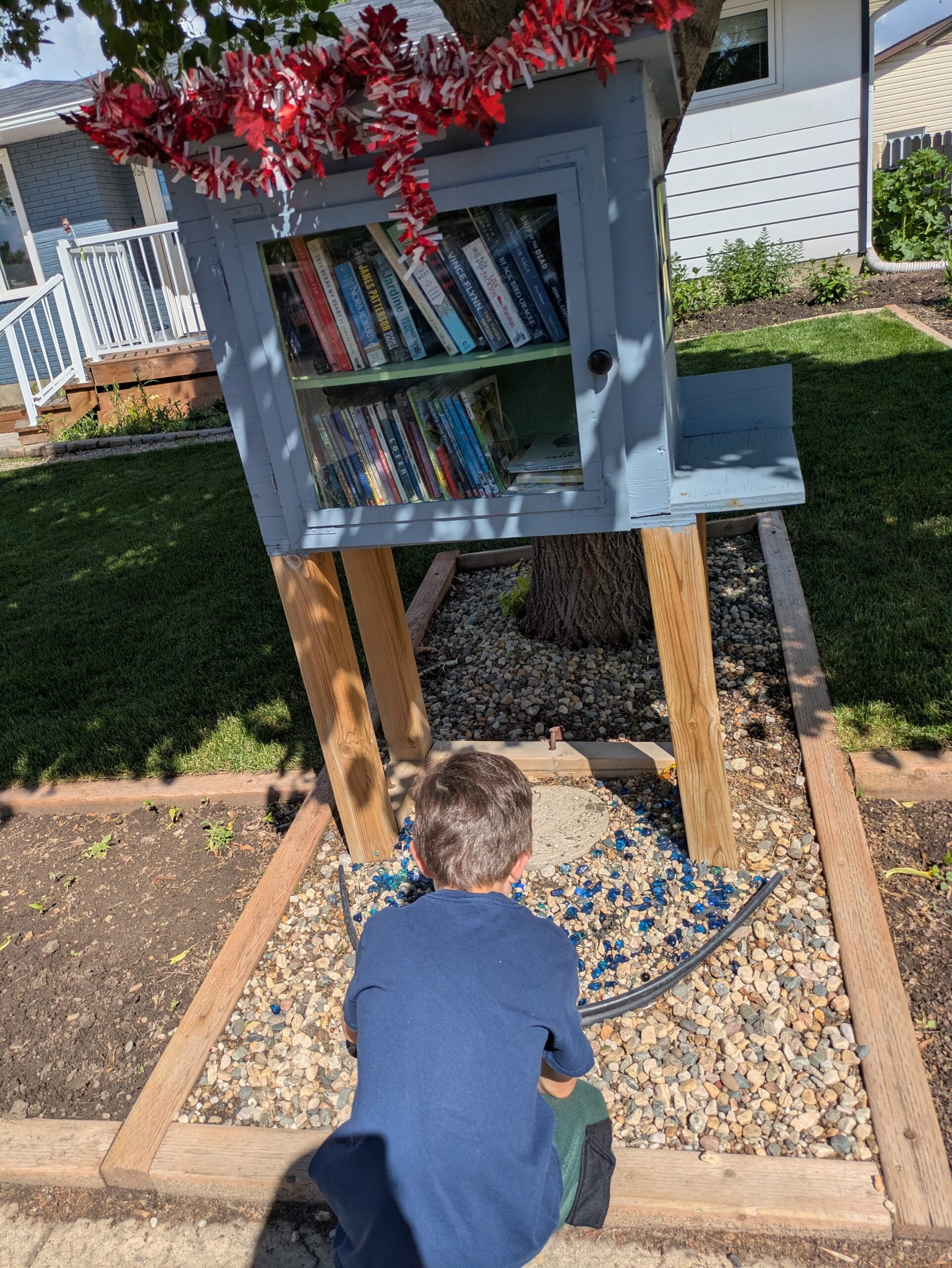 the summer we explored - visiting a free little library in saskatoon