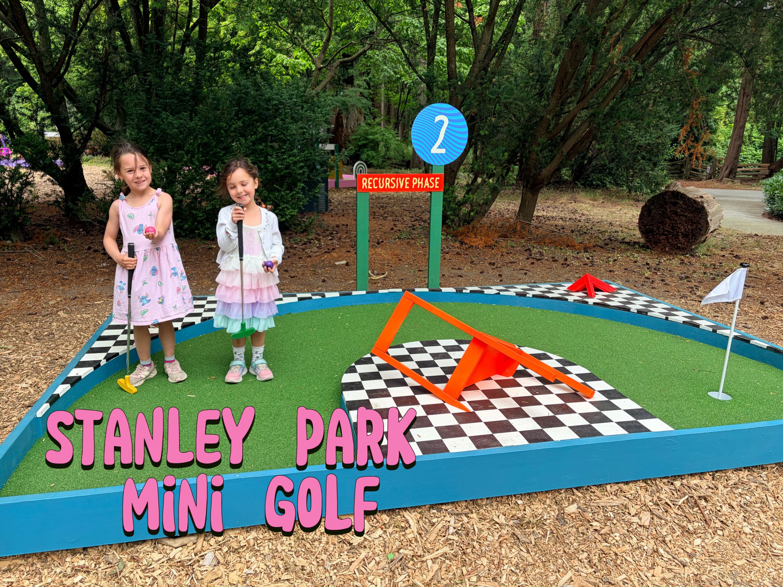 Girls playing mini golf