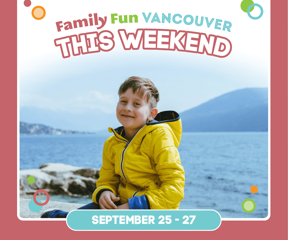 Boy in a yellow jacket sitting in front of water.