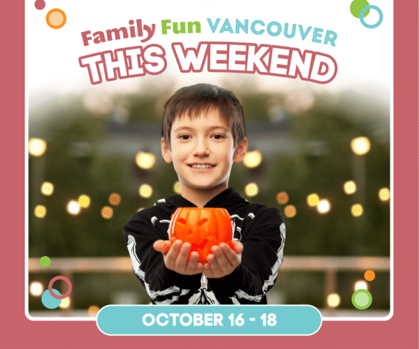 Boy in skeleton costume holding a pumpkin