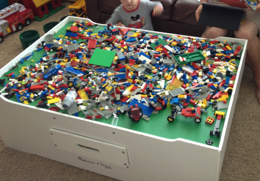 A mess of LEGO on a Train Table