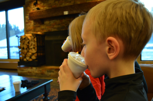 Sipping free hot chocolate in front of the fireplace at the Delta Lodge at Kananaskis.