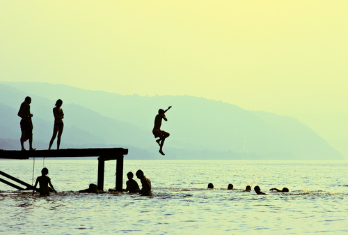 Jumping into the lake off the dock Via Shutterstock