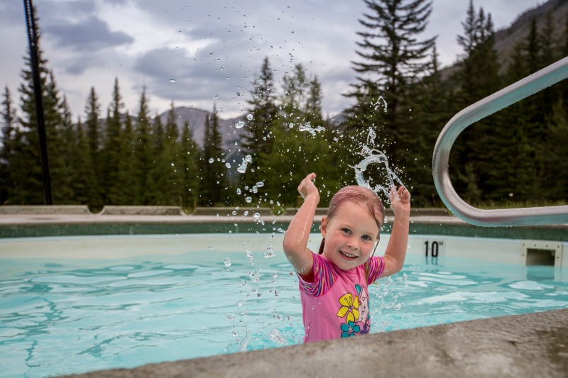 A small girl in the cold pool at the Miette Hot Springs. Credit Parks Canada Olivia Robinson