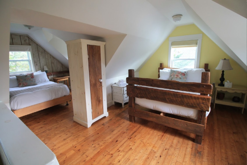 The Pines Cottage at the Oceanstone, Peggy's Cove - photo by Helen Earley - Upstairs, two bedrooms rest under an open beam roof.
