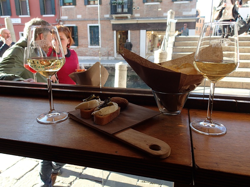 Enjoying chicchetti, inside and out at Osteria Al Pugni - photo Debra Smith