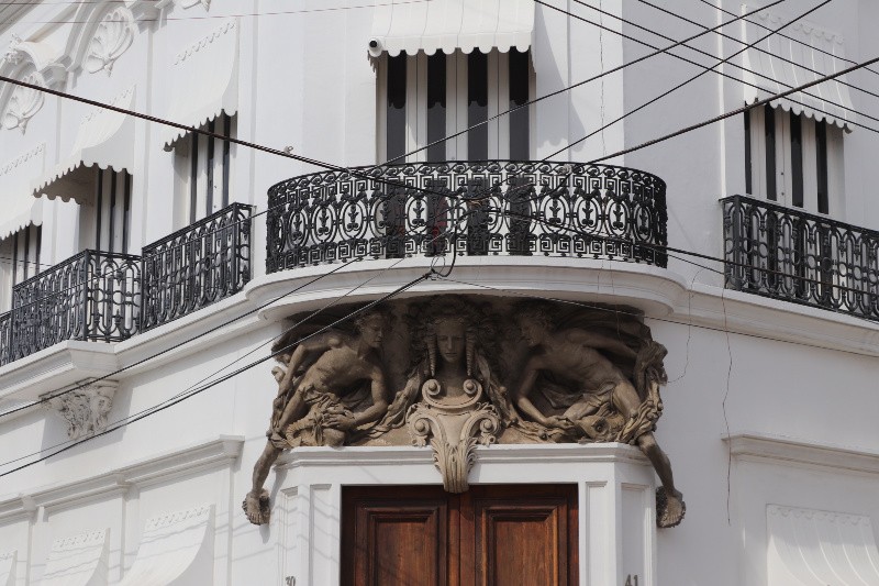 Historic colonial building in Mazatlan Mexico with wrought iron detail and other architectural adornments ornate