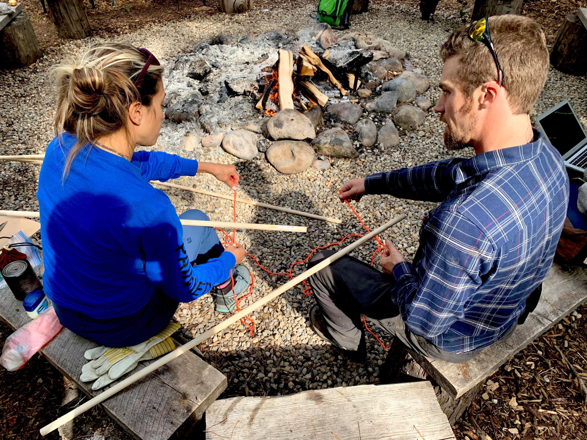 Painted Warriors Bimose Forest Walk - Rebecca (links) lernt, wie man eine Nelkenkupplung bindet, um das Stativ zum Kochen über einem Feuer zu sichern. Foto Robyn Louie